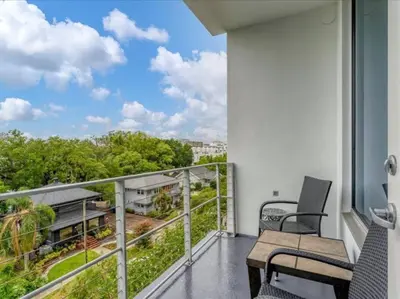 a balcony with a bench and a view of trees at Luxury 1260sq ft 2 Bd 2BTH in DT in Orlando