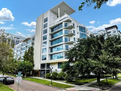 a large white building with trees in front of it at Luxury 1260sq ft 2 Bd 2BTH in DT in Orlando