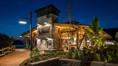 a stone building with lights on it at night at Disney's Wilderness Lodge in Orlando