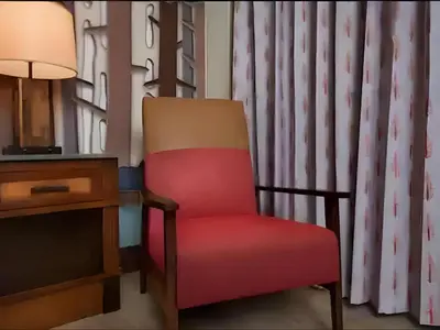a red chair sitting next to a desk with a lamp at Disney's Wilderness Lodge in Orlando