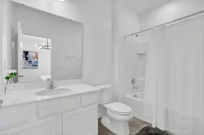 a white bathroom with a toilet and a sink and a tub at Amazing 15 Bedroom house at Veranda Palms 2395RAMA villa in Kissimmee
