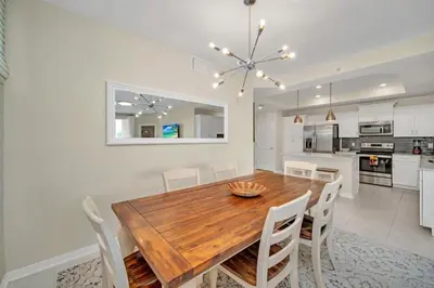 a kitchen and dining room with a wooden table and chairs at 4741Clock Unit208 townhouse in Kissimmee