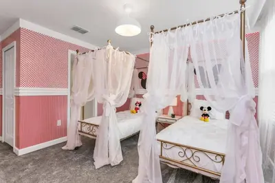 two beds in a bedroom with white drapes at 4552Target home in Kissimmee