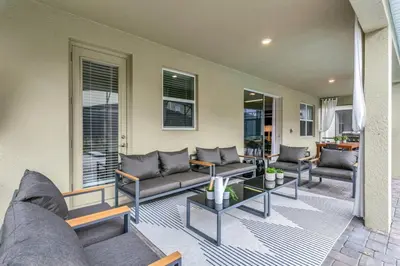 a living room with couches and tables and windows at 4552Target home in Kissimmee