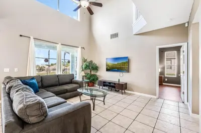 a living room with a couch and a table at Emerald Island Large 8 Bed Home Golf Resort villa in Kissimmee