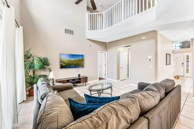 a large living room with a large couch at Emerald Island Large 8 Bed Home Golf Resort villa in Kissimmee
