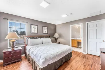 a bedroom with a bed and a desk and a window at Emerald Island Large 8 Bed Home Golf Resort villa in Kissimmee
