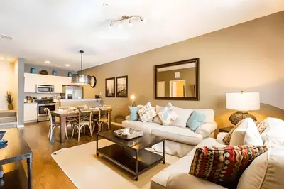 a living room with a couch and a table at Casa 3Q West Lucaya – Perto da Disney c/ Clubhouse in Kissimmee