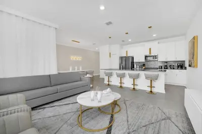 a living room with a couch and a table at Luxury 4 Bedroom Storey Lake Townhome 2444Reading townhouse in Kissimmee