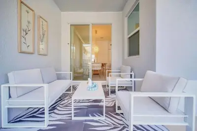 a living room with white chairs and a table at Luxury 4 Bedroom Storey Lake Townhome 2444Reading townhouse in Kissimmee