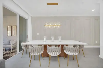 a dining room with a white table and chairs at Luxury 4 Bedroom Storey Lake Townhome 2444Reading townhouse in Kissimmee