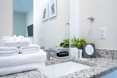 a bathroom with a counter with towels and a mirror at RCT Dreamstay in Orlando
