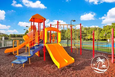 a playground with an orange and blue slide at Deluxe 4 bedrooms Villa at Seven Dwrafs Resort - Close to Disney in Kissimmee