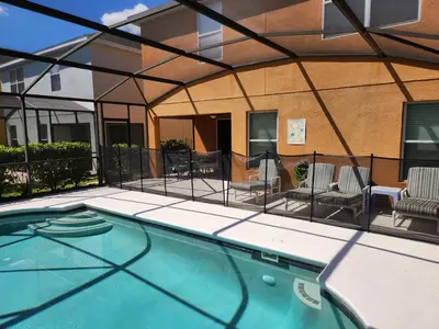 a view of a swimming pool with a patio with chairs at 299- Fabulous 4 Bed Modern Decor Villa with Private Pool Overlooking Conservation and Water View in Kissimmee