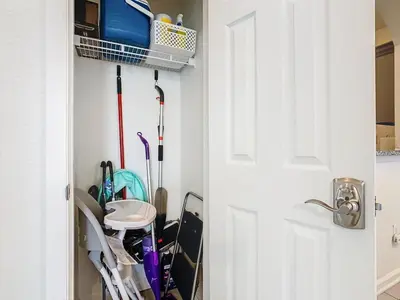a closet with a door open with golf clubs at Windsor Hills Cozy 3 BR Condo, Starwars, By Disney in Orlando