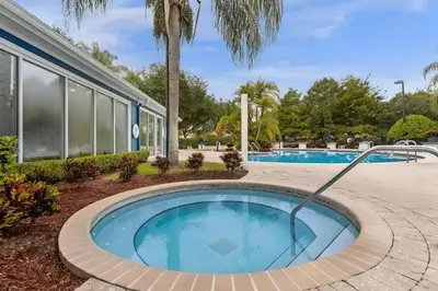 a swimming pool with a roundabout in front of a building at Casa 3Q c/ Piscina de Resort e sala de jogos in Kissimmee