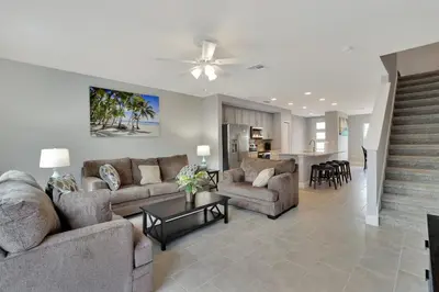 a living room with two couches and a table at Spectacular! Townhome 9 Miles to Disney World! in Kissimmee