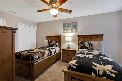 a bedroom with two beds and a ceiling fan at Spectacular! Townhome 9 Miles to Disney World! in Kissimmee