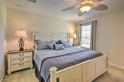 a bedroom with a large bed and a ceiling fan at Look over Nature, Pool Home Near Disney Parks in Kissimmee