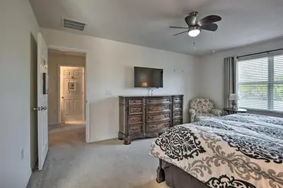 a bedroom with a bed and a flat screen tv at Look over Nature, Pool Home Near Disney Parks in Kissimmee