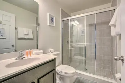 a bathroom with a shower and a toilet and a sink at Look over Nature, Pool Home Near Disney Parks in Kissimmee