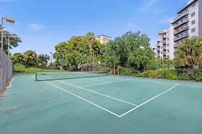 a tennis court with a net on top of it at 22 -The heart of International Dr - Universal in Orlando