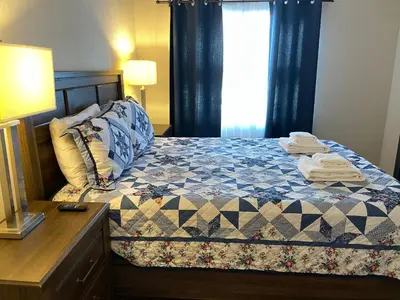 a bedroom with a bed and a dresser and a window at 22 -The heart of International Dr - Universal in Orlando