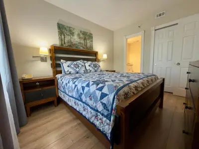 a bedroom with a bed with a blue comforter at 29-Universal, International Dr,Convention Center in Orlando