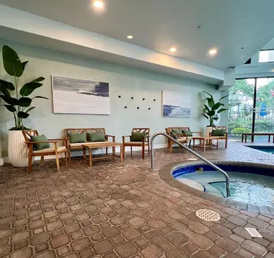 a lobby with a pool and chairs and a table at 29-Universal, International Dr,Convention Center in Orlando