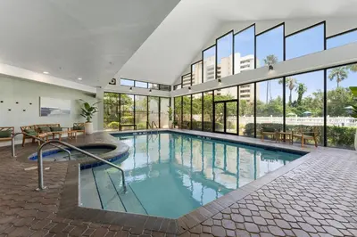 a large swimming pool in a building with windows at 14-Near Universal Studios Amazing View in Orlando