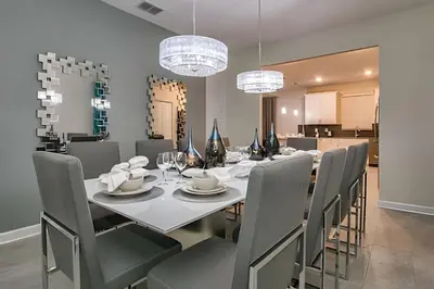 a dining room with a long table and chairs at Casa 7Q perto da Disney com Piscina e Games in Kissimmee