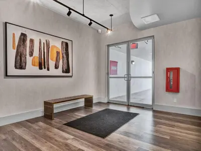 an empty room with a bench and paintings on the wall at Extra Large 1 Bdrm Condo & Gym in Orlando