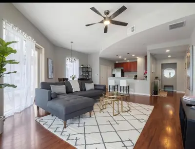 a living room with a couch and a ceiling fan at Extra Large 1 Bdrm Condo & Gym in Orlando