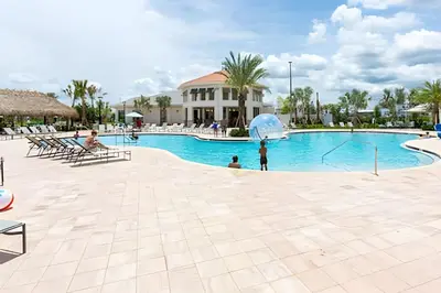 a family playing in the pool at a resort at Casa 5Q c/ Piscina – 10min da Disney + Resort in Kissimmee
