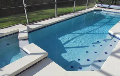 a large swimming pool with blue water at Grand Cumbrian - Four Bedroom Home in Kissimmee