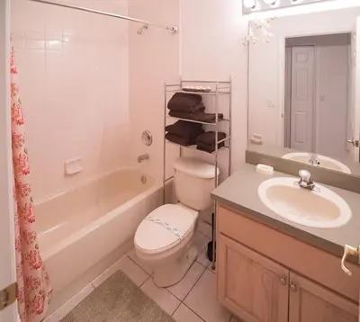 a bathroom with a sink and a toilet and a bath tub at Cumbrian Retreat in Kissimmee