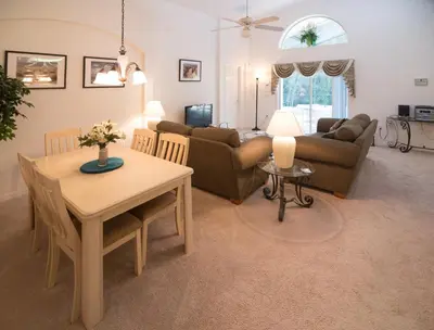 a living room with a table and a couch at Cumbrian Retreat in Kissimmee