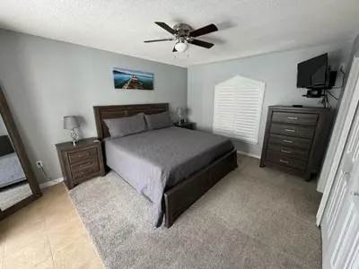 a bedroom with a bed and a ceiling fan at Villa Crayson in Kissimmee