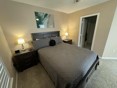 a bedroom with a bed with two night stands and two lamps at Villa Crayson in Kissimmee