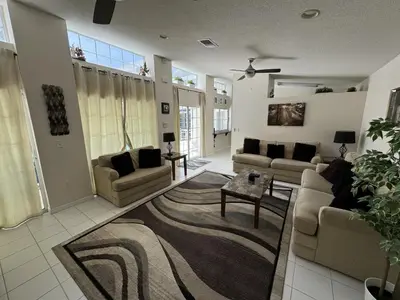 a living room with two couches and a rug at Villa Crayson in Kissimmee