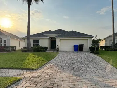 a house with a driveway with a garage at Casablanca Villa in Kissimmee