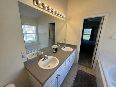 a bathroom with two sinks and a large mirror at Casablanca Villa in Kissimmee