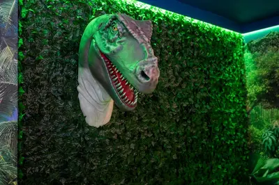 a green hedge with a dinosaur head on it at Brand New 12-bedroom Amazing house 5869 in Orlando