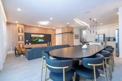 a kitchen and dining room with a table and chairs at Brand New 12-bedroom Amazing house 5869 in Orlando