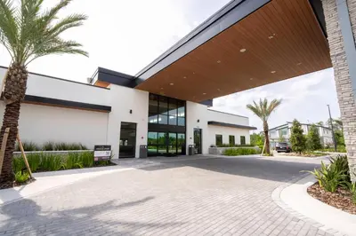a building with a palm tree in front of it at Brand New 12-bedroom Amazing house 5869 in Orlando