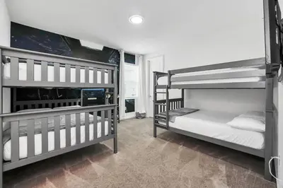 two bunk beds are in a room with at Spacious Dreamscape 12rooms 11 bathrooms 25 people Wifi in Kissimmee