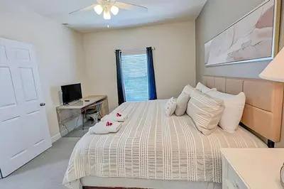 a bedroom with a bed and a desk with a computer at Casa 4Q perto da Disney c/ Resort e Padaria in Kissimmee