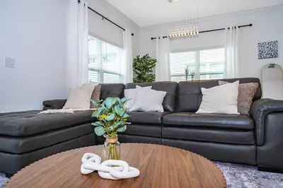 a living room with a couch and a table at Epic Elegance Home Resort Amenities Disney10 miles in Kissimmee