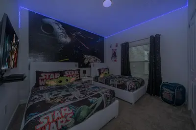 a bedroom with two beds and a star wars mural at Epic Elegance Home Resort Amenities Disney10 miles in Kissimmee