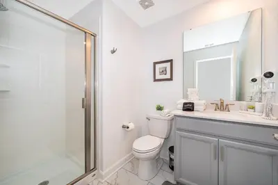 a bathroom with a shower and a toilet and a sink at Epic Elegance Home Resort Amenities Disney10 miles in Kissimmee